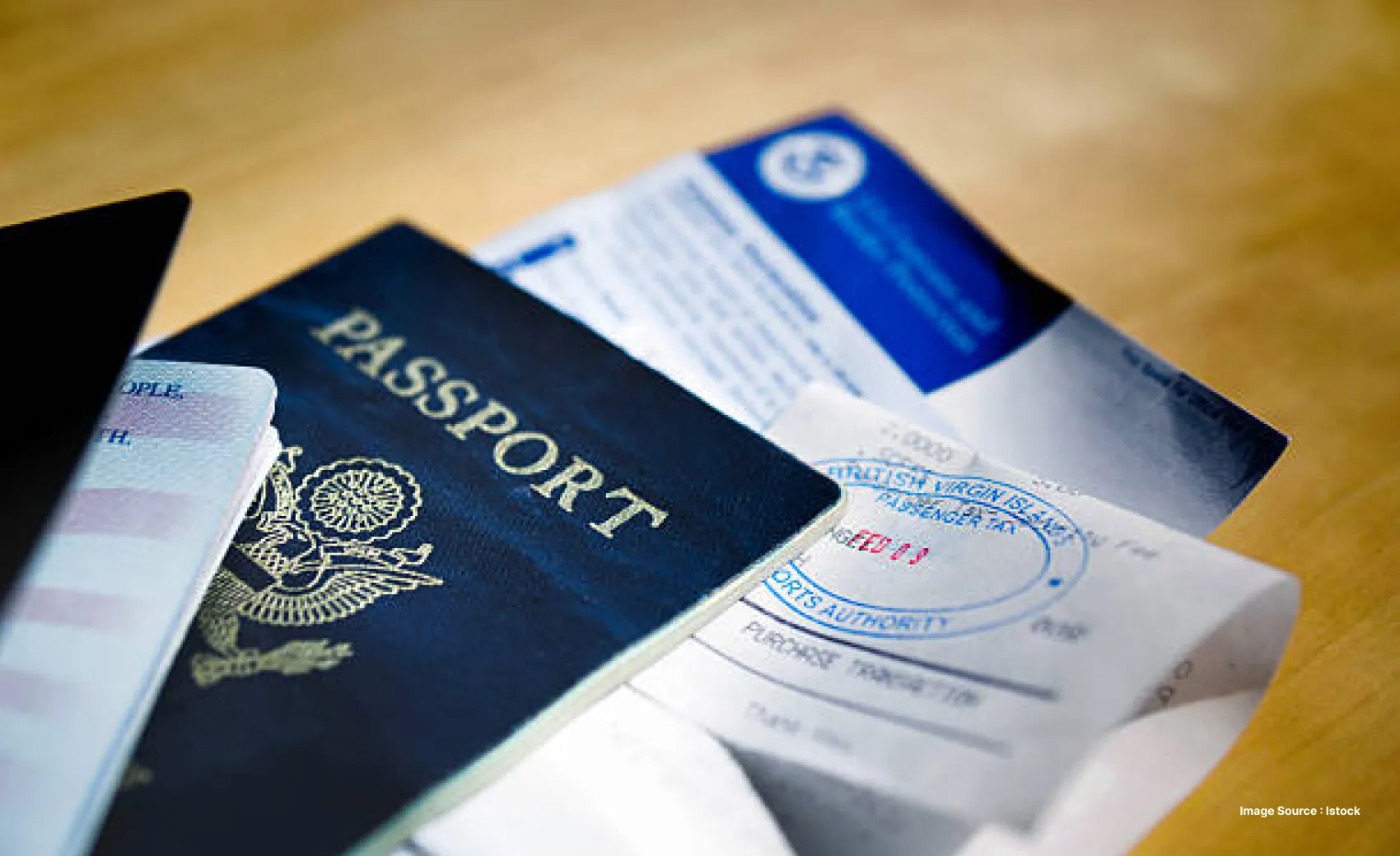 travel documents such as a passport and boarding pass laid out on a table