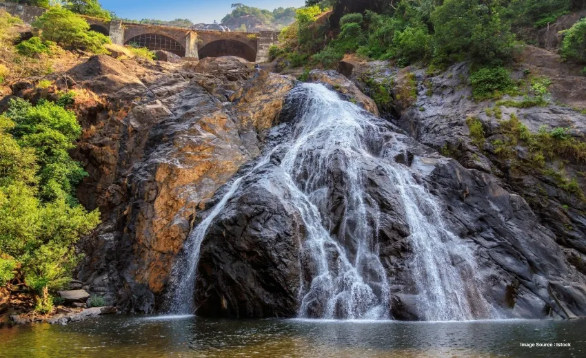  a small waterfall with white waters on a beautiful landscape