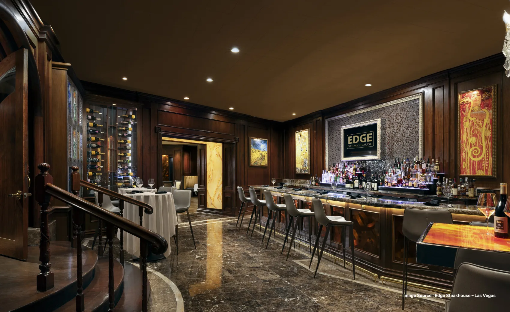 a dimly lit fine dining spot in westgate las vegas with wooden stairs and a bar counter