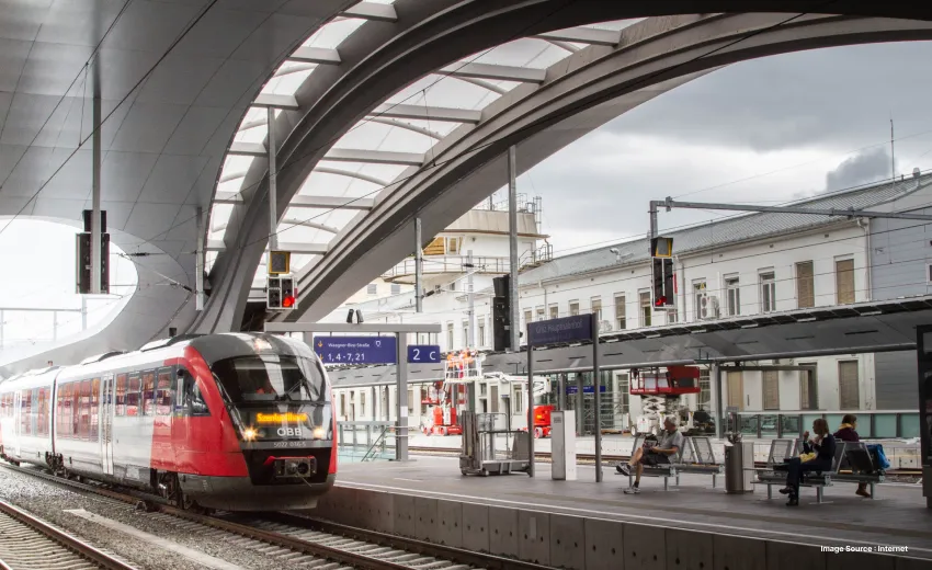 a european train station with a modern looking train waiting at the platform