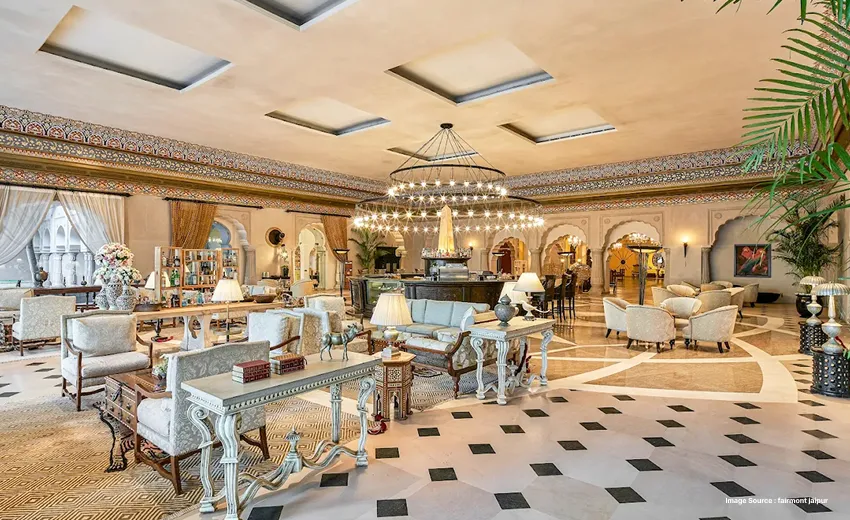 Luxurious hotel lobby with grand chandelier, elegant seating, and ornate interiors.
