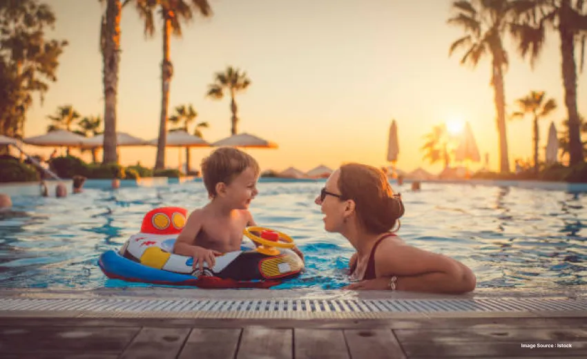 a mother enjoying the pool with her child who is in a floatie