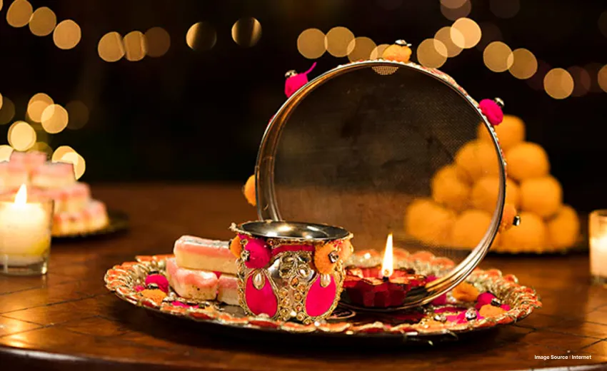 karwa chauth items like the strainer and pitcher decorated on a plate to break the fast