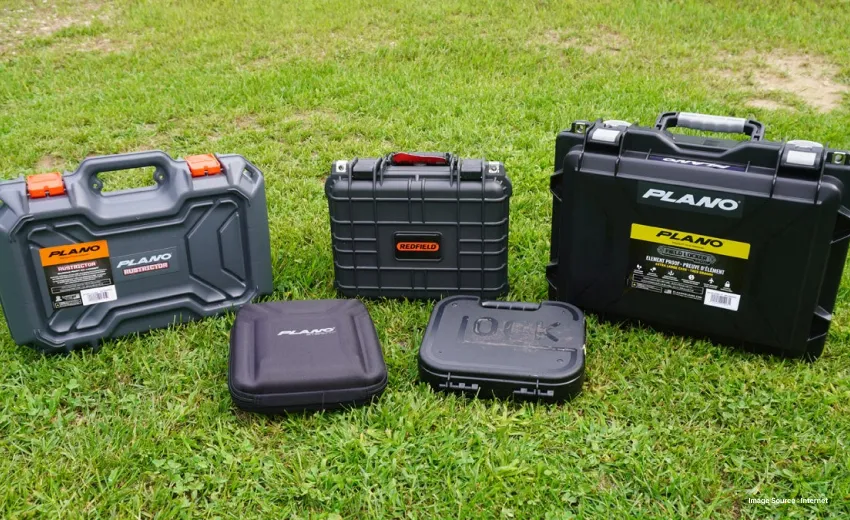 a bunch of grey hard cases presented on grass