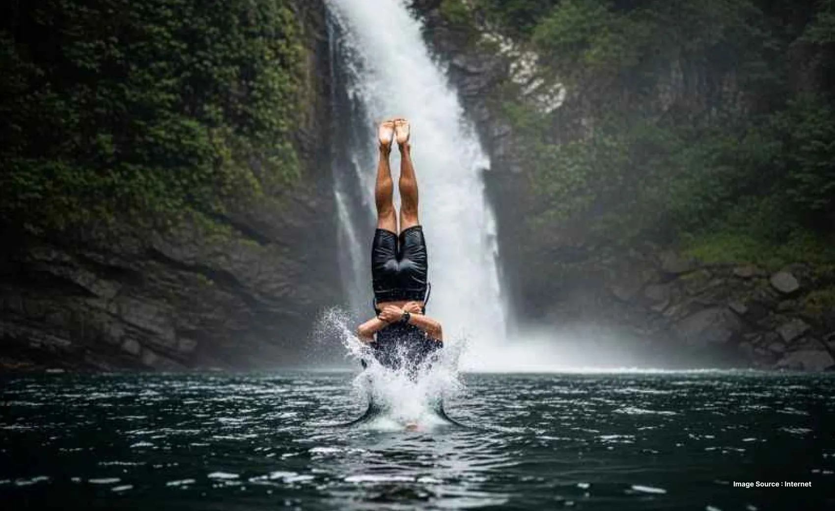 a person upside down falling into a waterfall's plunge pool headfirst