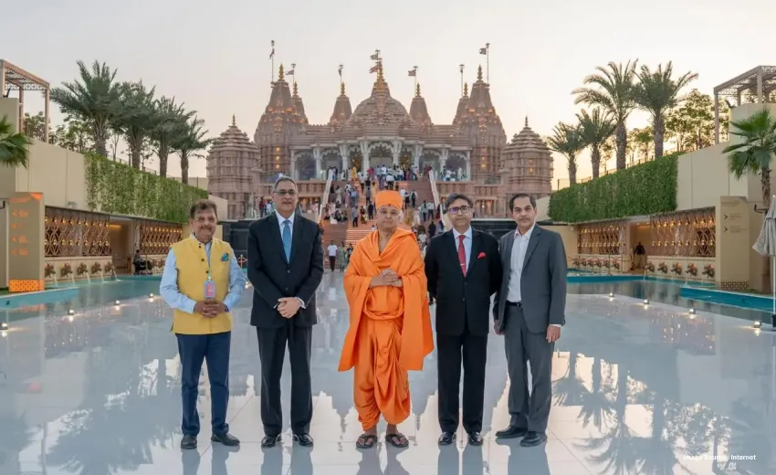 4 people standing in front of a Hindu temple