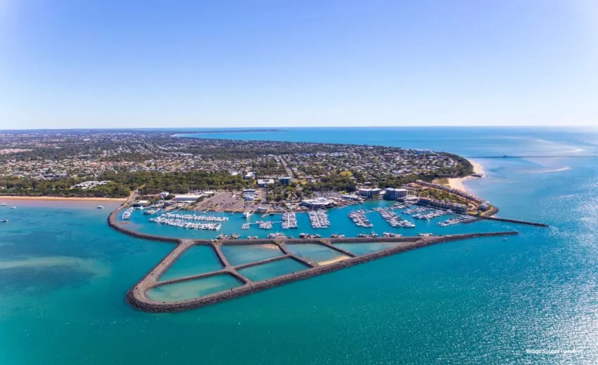 aerial shot of the hervey bay with patterned decks and the city in the background