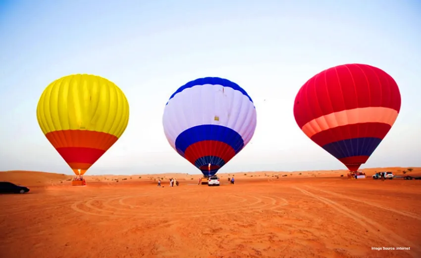Hot air balloons preparing for a desert adventure experience