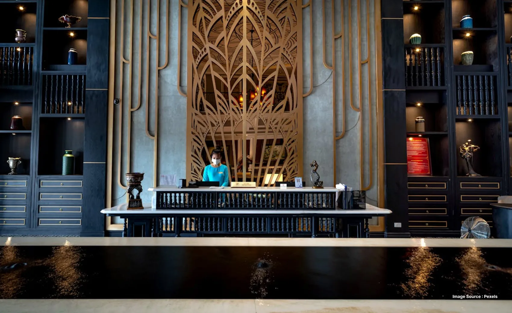 a masked lady tourist signing hotel paperwork on the reception