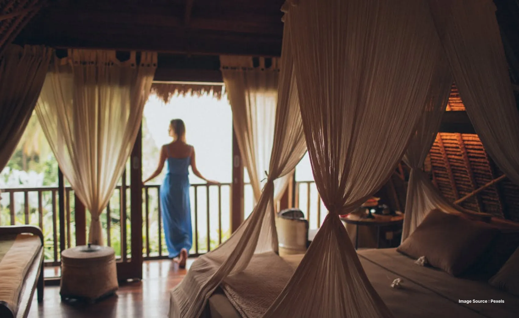 a unique boutique property stay with a lady dressed in blue standing in the balcony enjoying the view