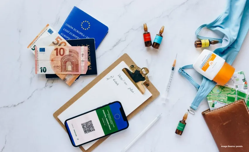 Travel essentials including passport, currency, and digital health pass