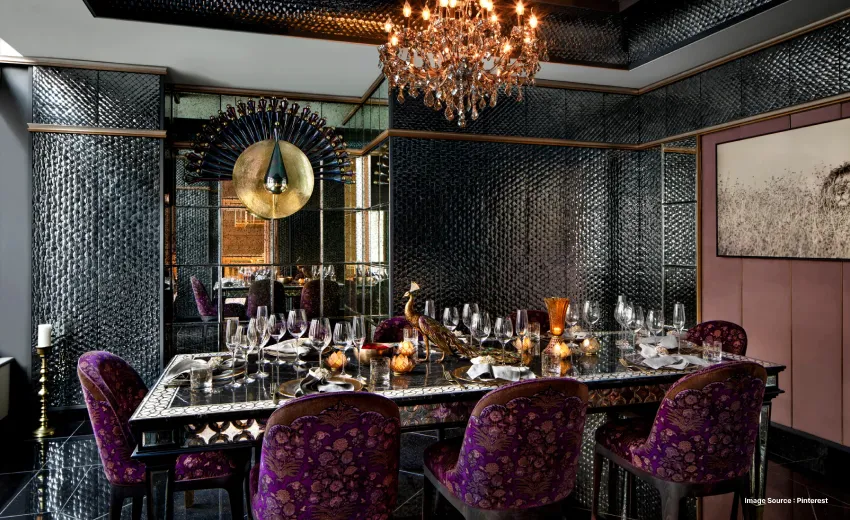 an upscale fine dining indian restaurant with purple chairs and chandelier