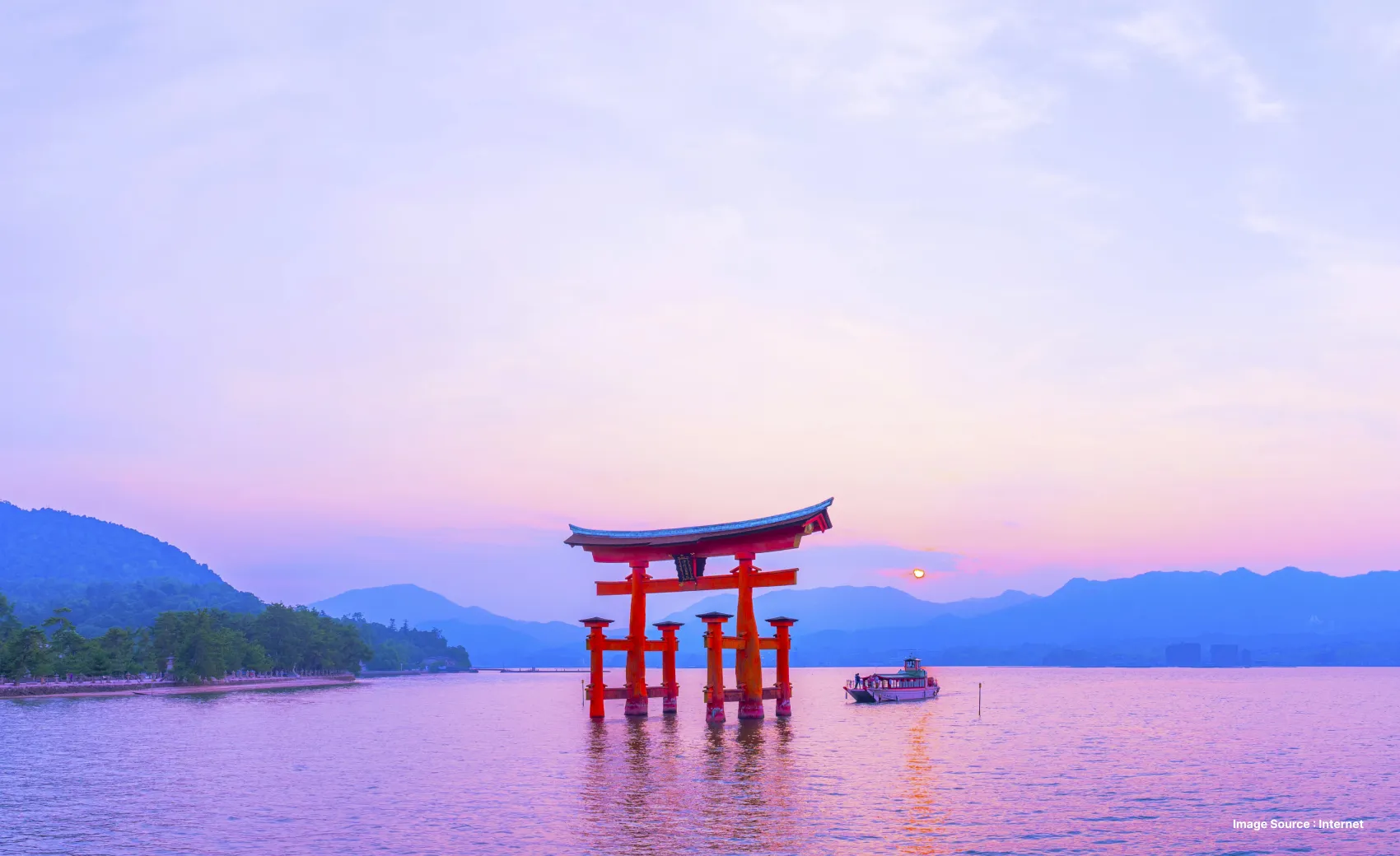 a japanese red gate in middle of a water body at sunset