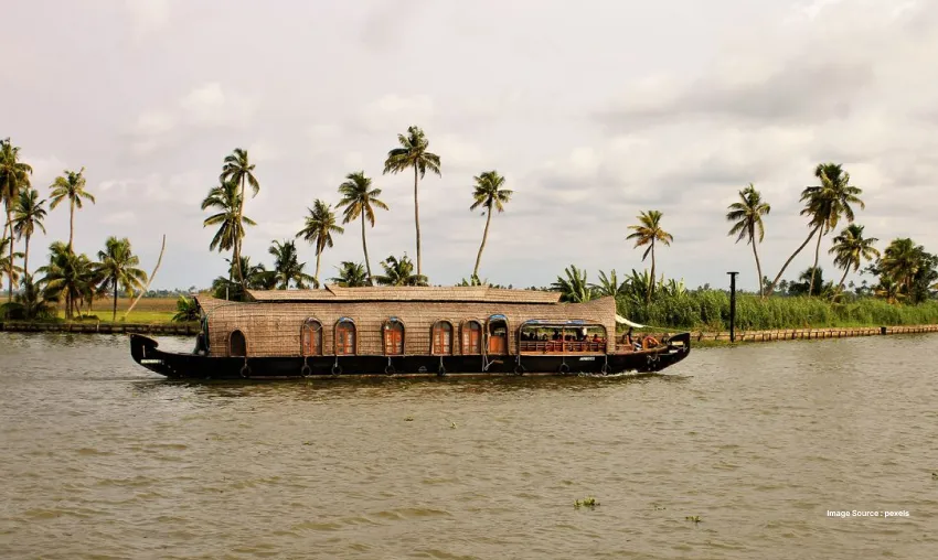 Traditional houseboat cruising through serene tropical backwaters