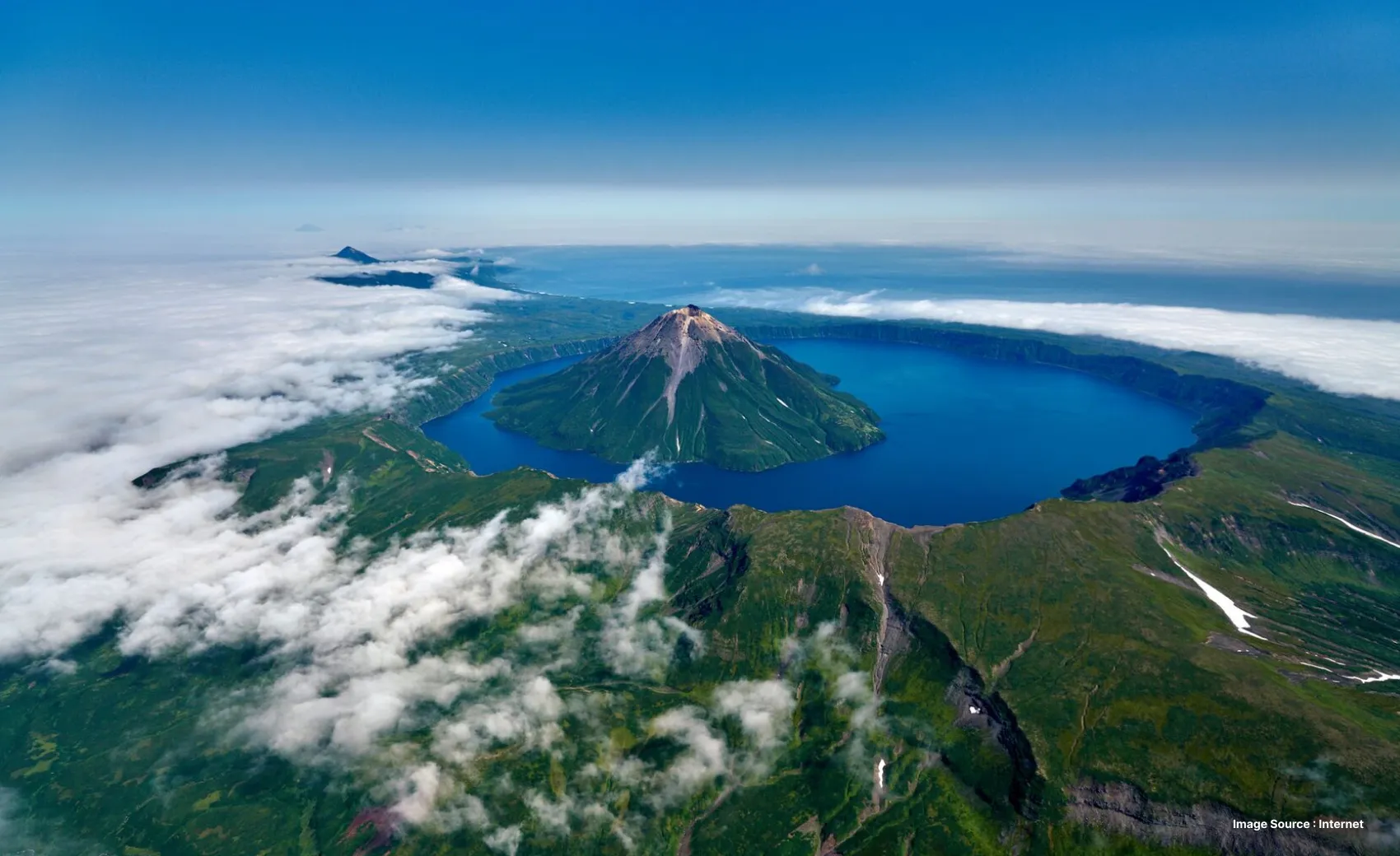 aerial shot with clouds in view of kuril islands with clear blue waters and greenery