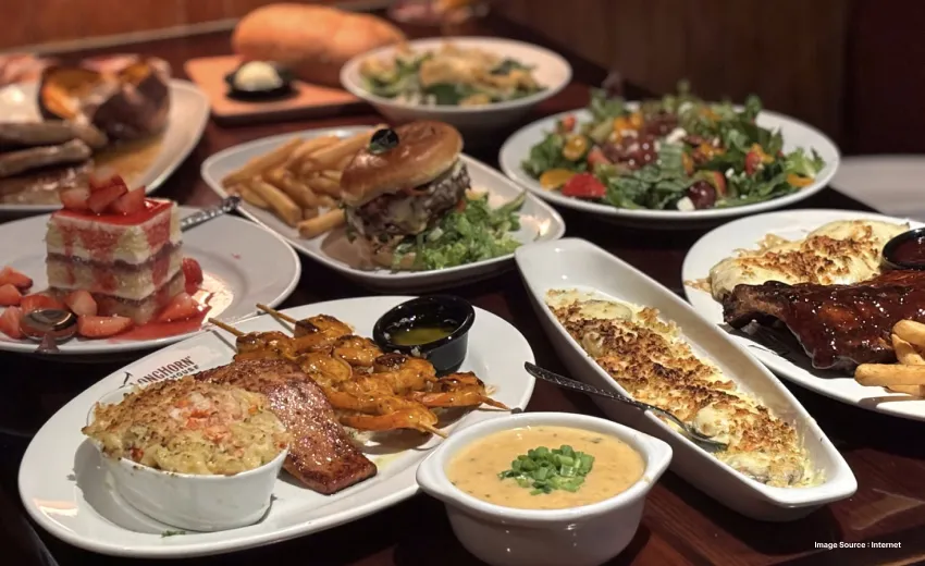 A complete feast at the longhorn steakhouse with burger and fries and bread and salads