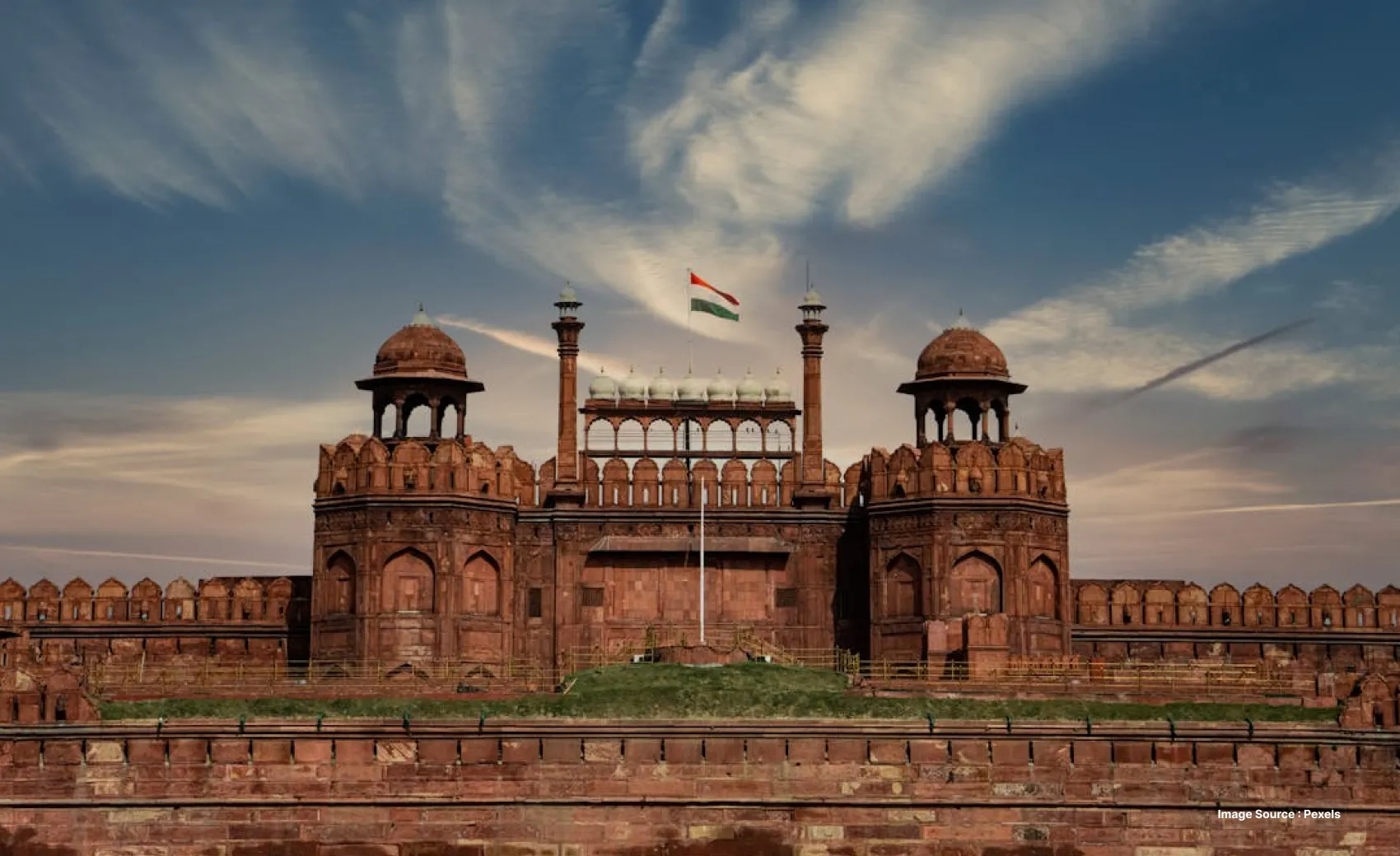 sunset view of the grand red fort with the indian tricolor