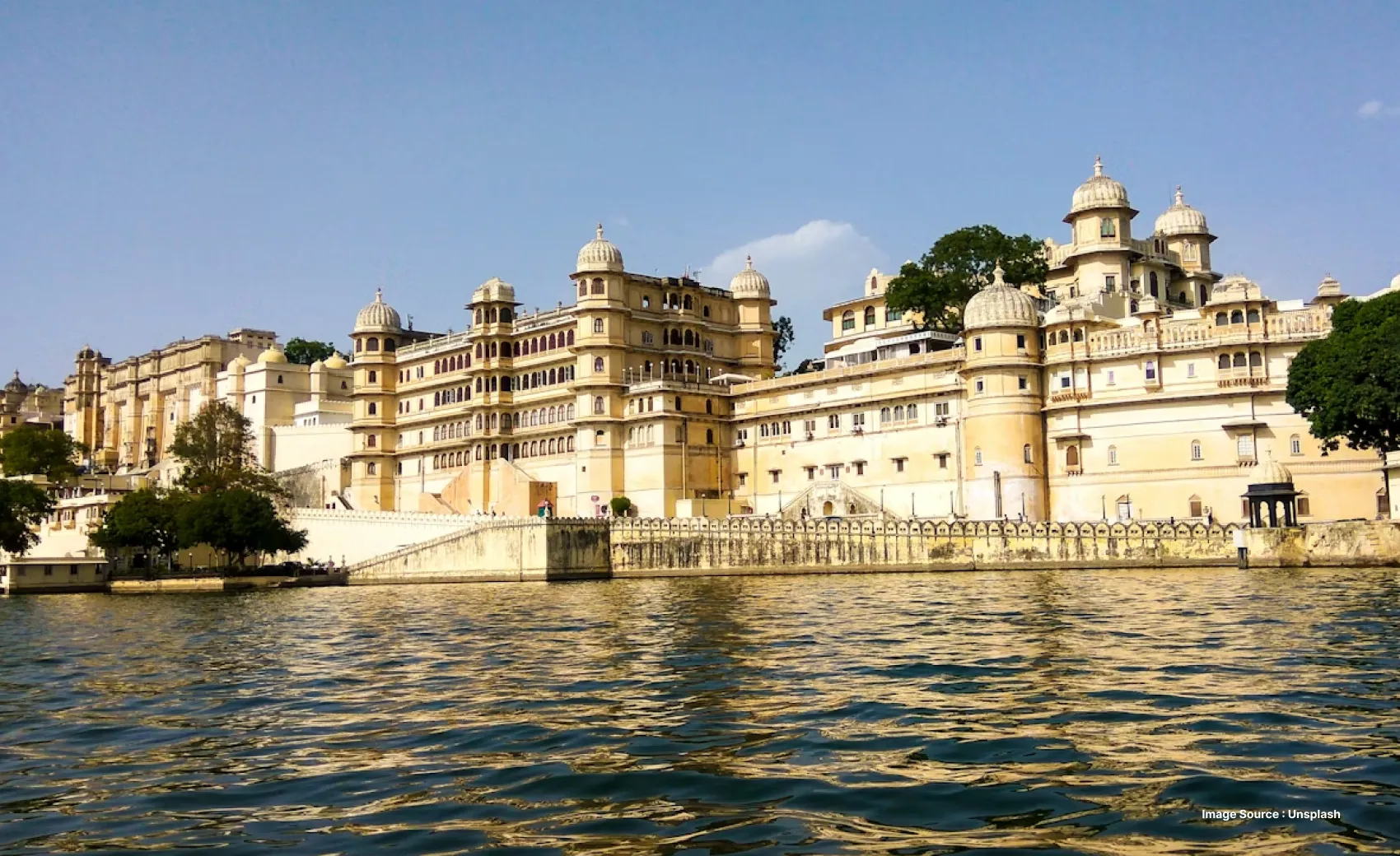 udaipur lakefront view with white mansions in daytime