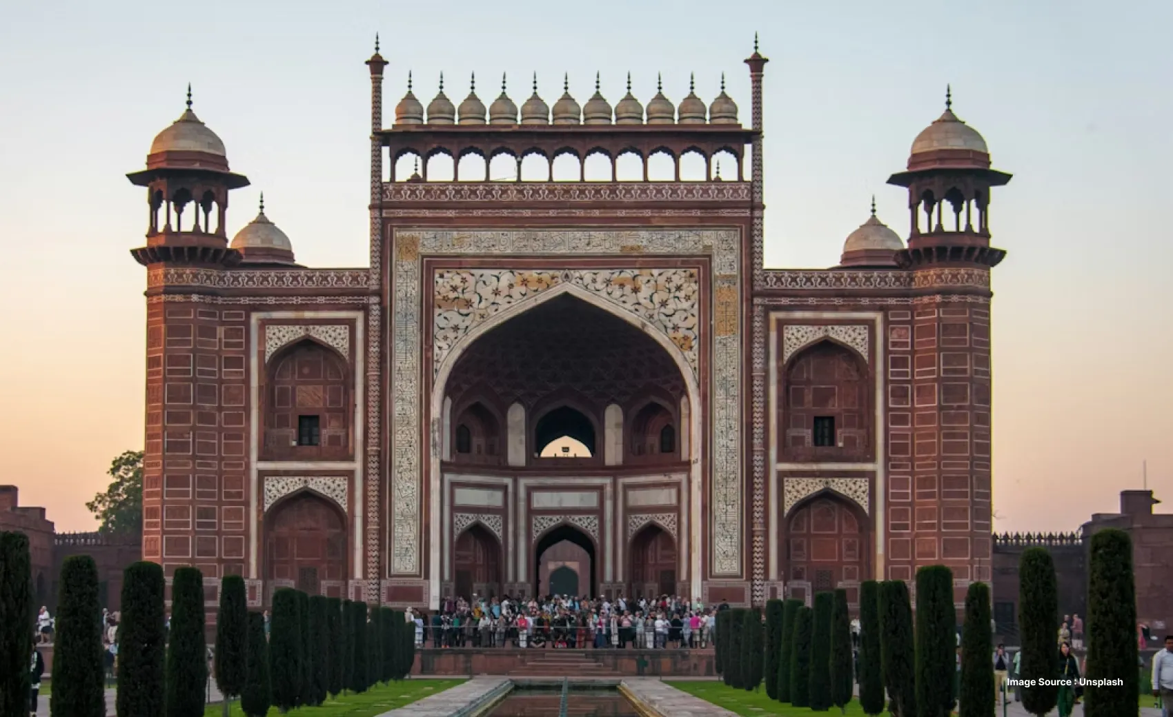 entrance gate of the taj mahal with intricate archway