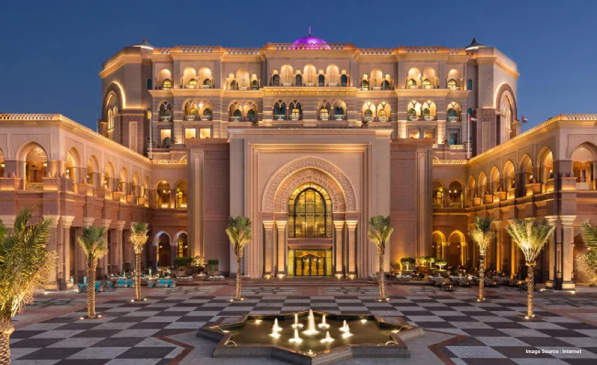 entrance of a luxury hotel with fancy architecture and golden lights at dusk