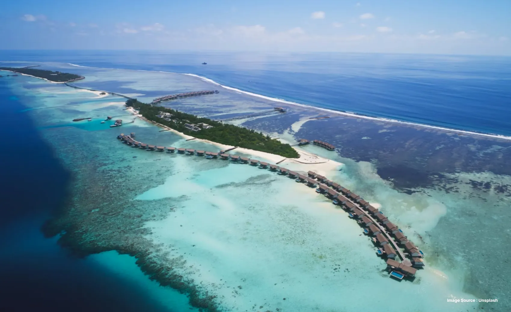 Aerial view of Maldives and overwater villas with clear blue waters