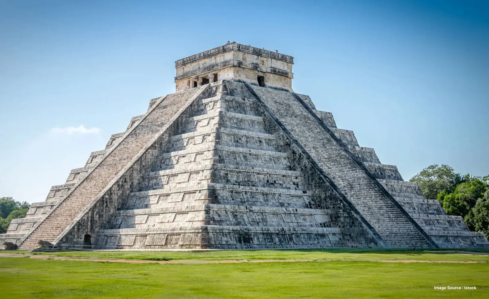 an ancient pyramidical structure with stairs, leading to the top
