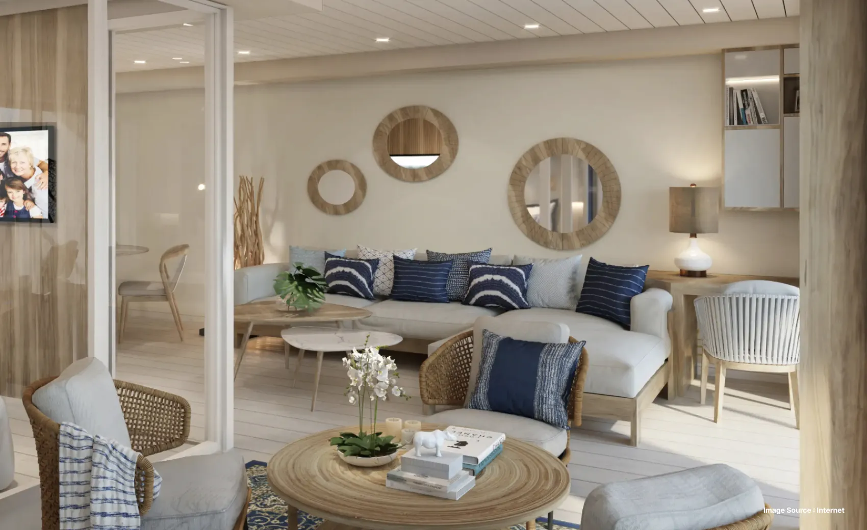 inside view of a luxurious cabin on a cruise decorated with mirrors and blue throw pillows
