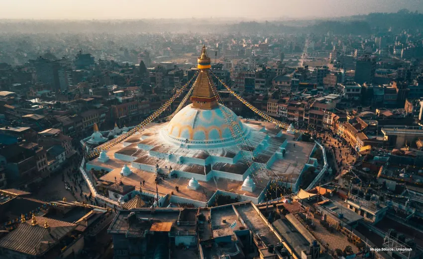 Iconic white stupa overlooking a bustling historic cityscape.