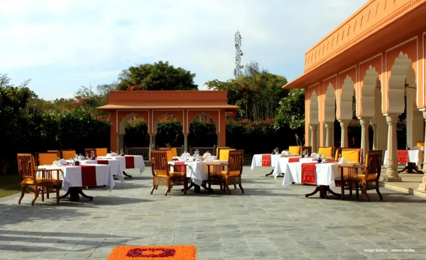 Elegant outdoor dining courtyard with heritage-inspired architecture and garden seating.