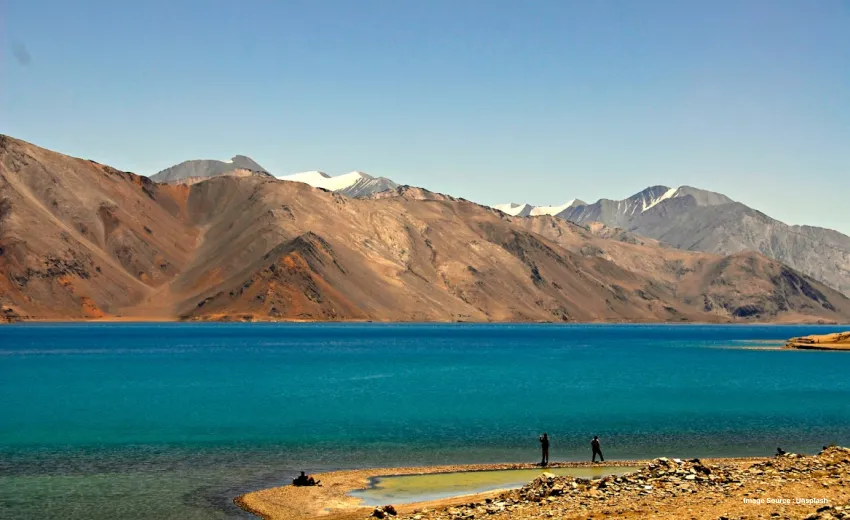 the pangong lake in ladakh with clear blue waters and rugged dry hills