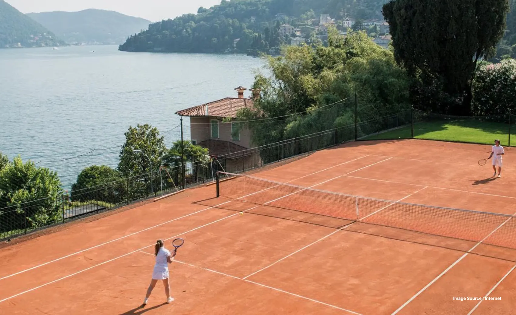 a woman playing tennis in white uniform by the scenic lake como