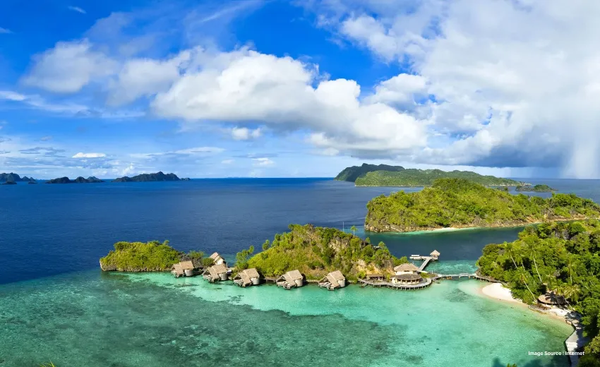 a boat stands parked with overwater shelters in a distance