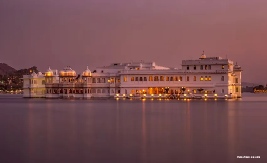 Luxury lake palace illuminated against a tranquil night backdrop