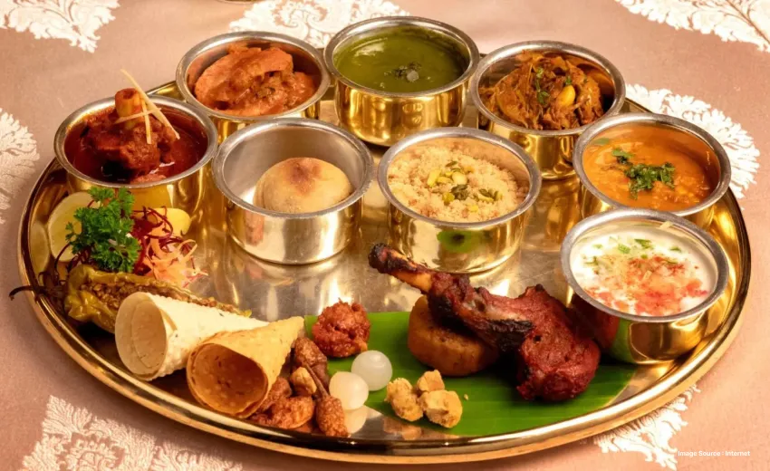 a traditional rajasthani cuisine platter served with multiple dishes and papad