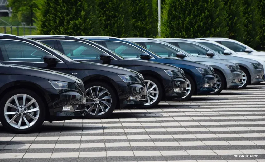 side view of a lane with parked black cars