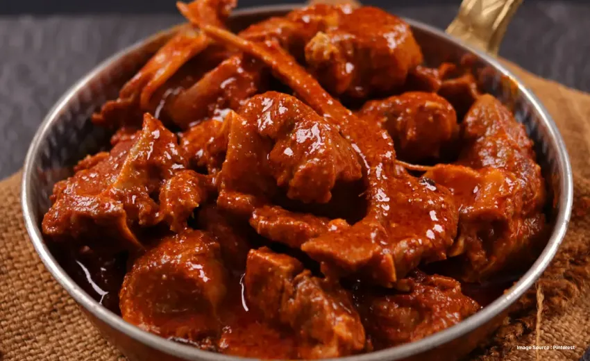 a close up shot of the fiery red rogan josh dish with meat