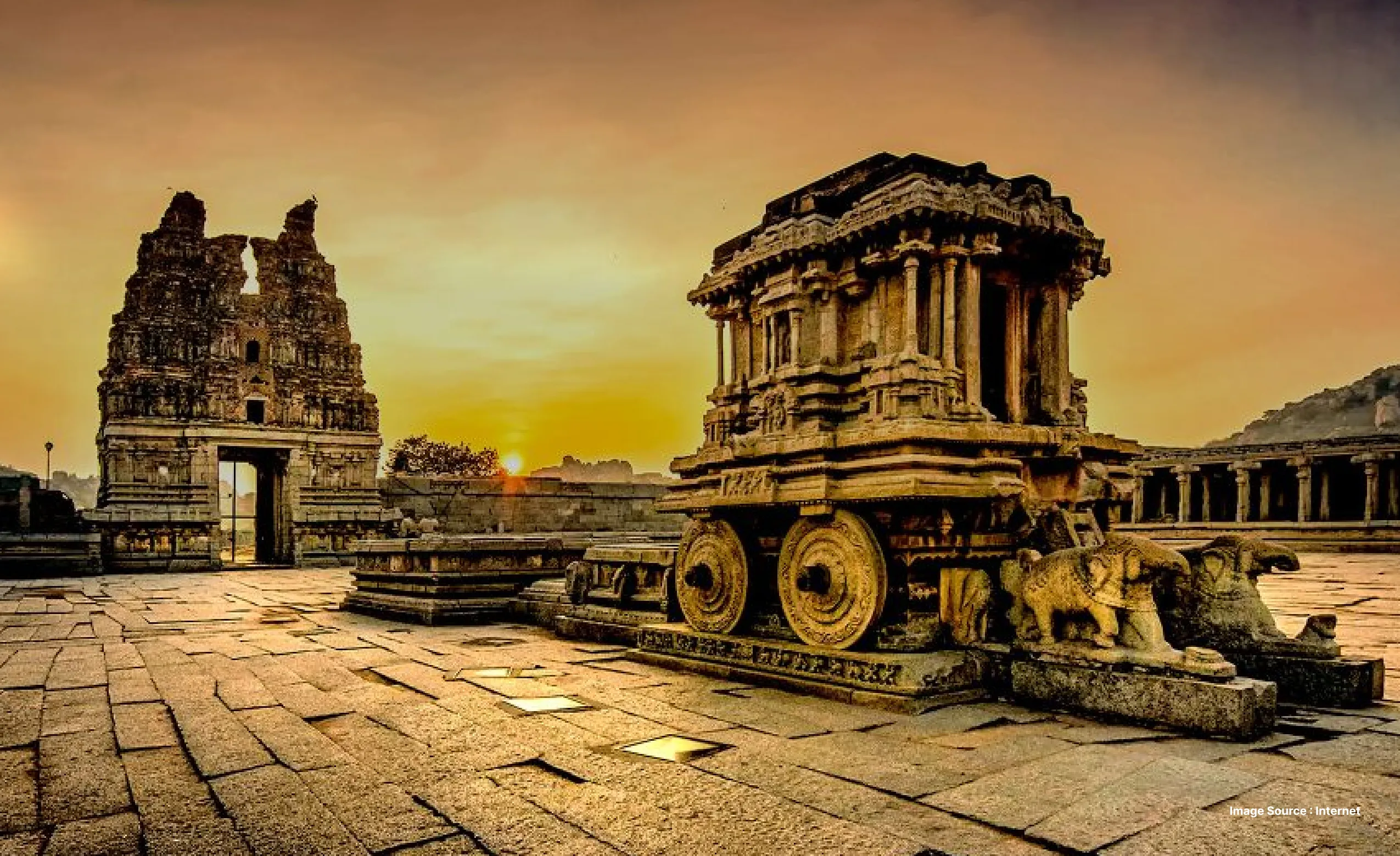 a dramatic shot of the chariot structure and an ancient gateway ruin at hampi during sunset