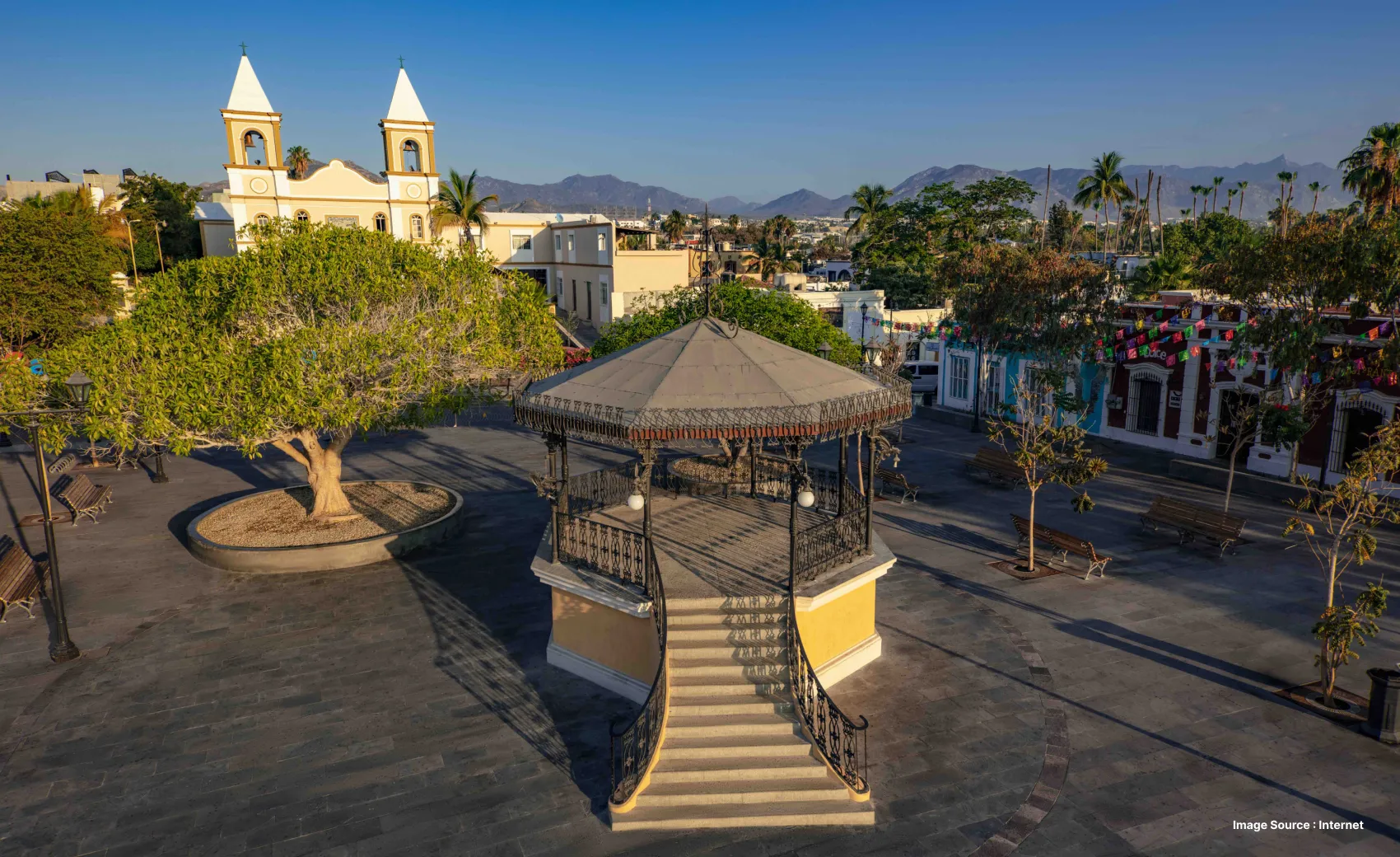 a serene view of cathedrals and a shaded pavilion with trees around