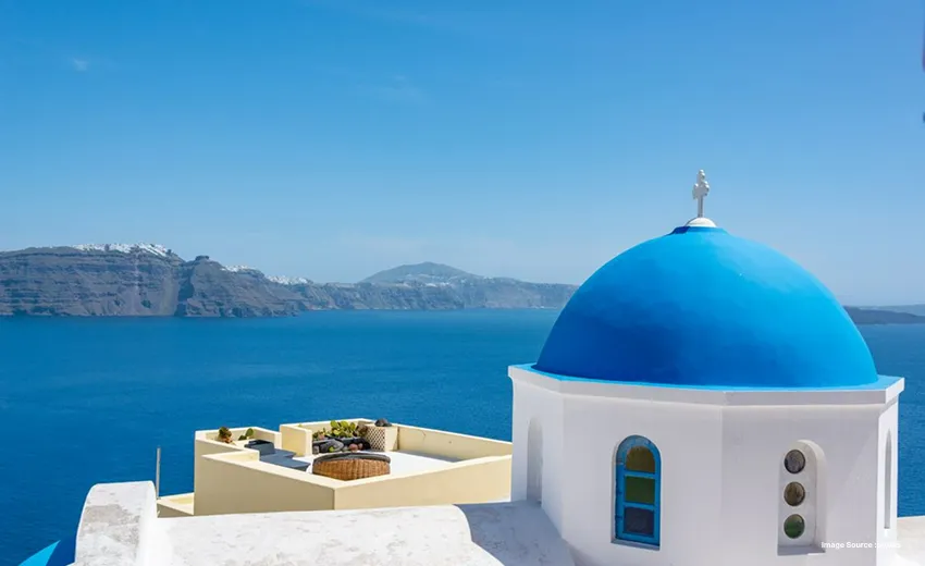 Iconic blue-domed chapel overlooking the Aegean Sea