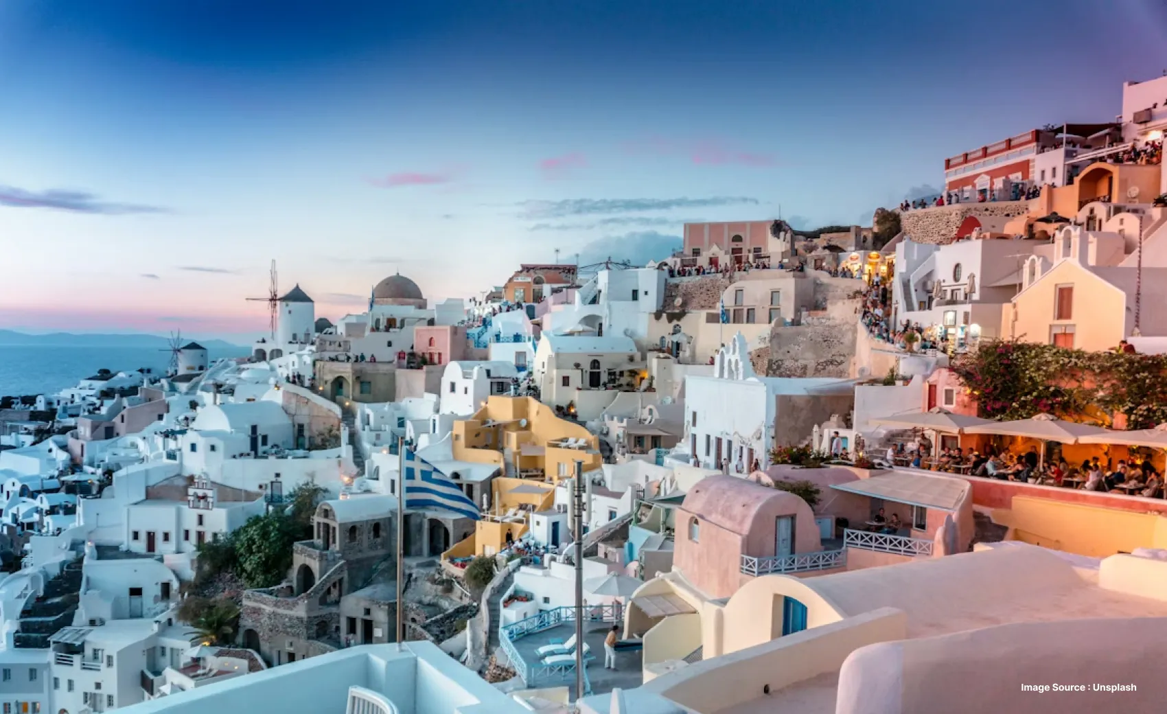 Beautiful white buildings with rooftops at sunset over a coastline