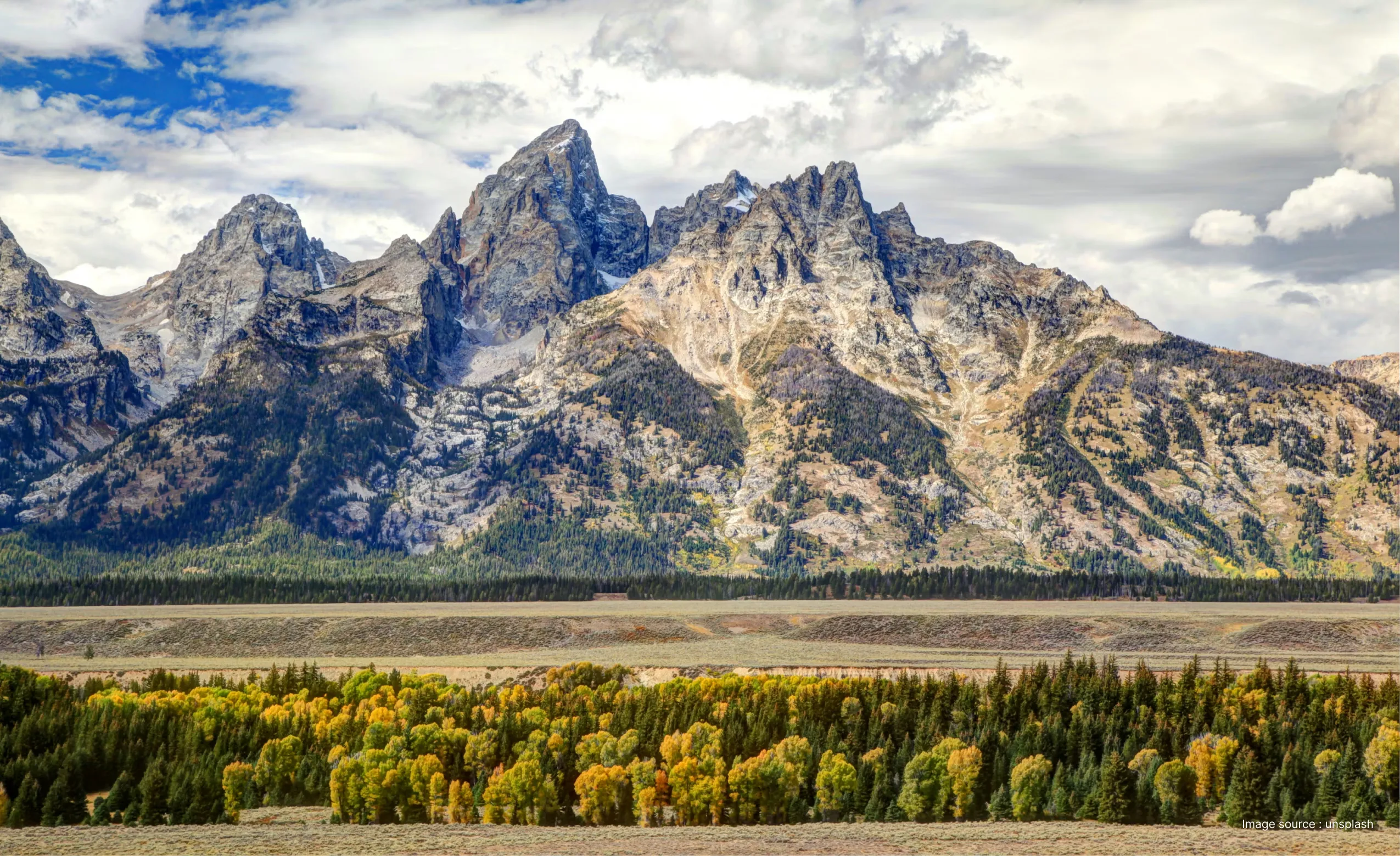 a view of the signal mountain summit with dramatic grey cliffs and clouds