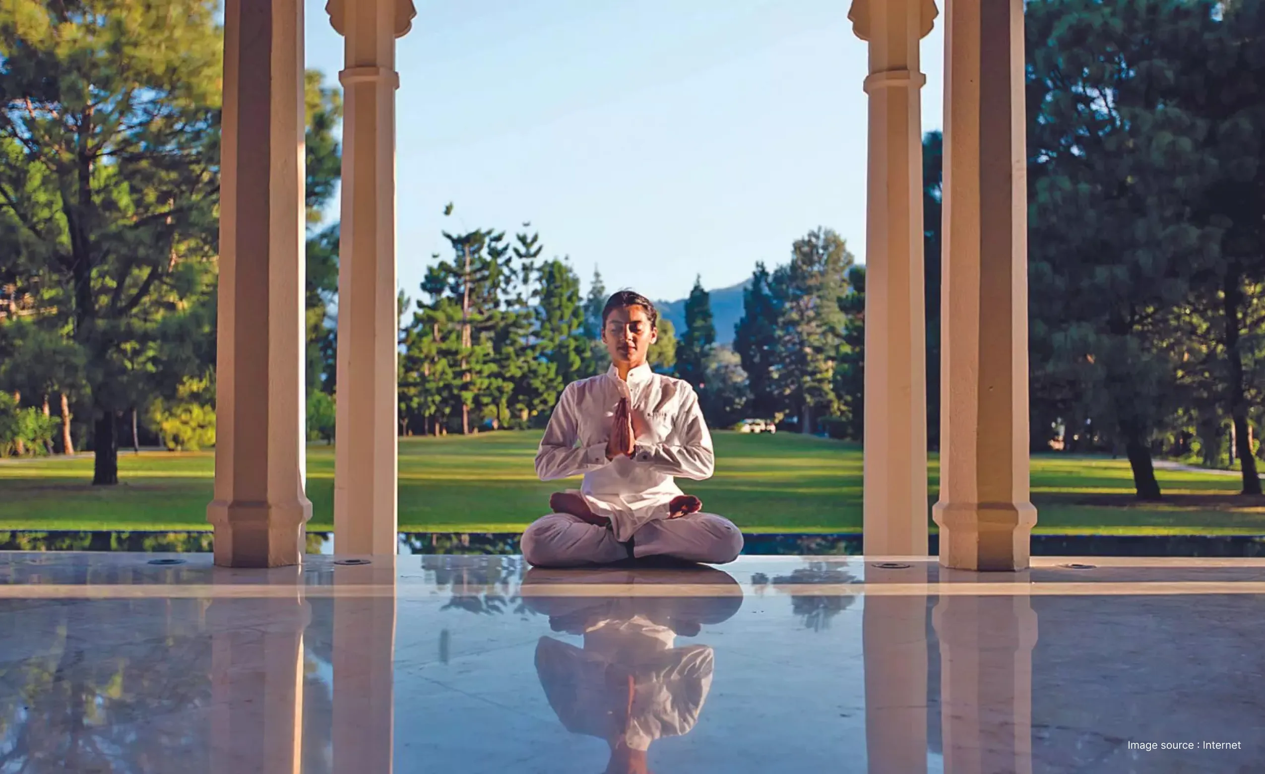 a lady practicing a yoga pose among the mountains