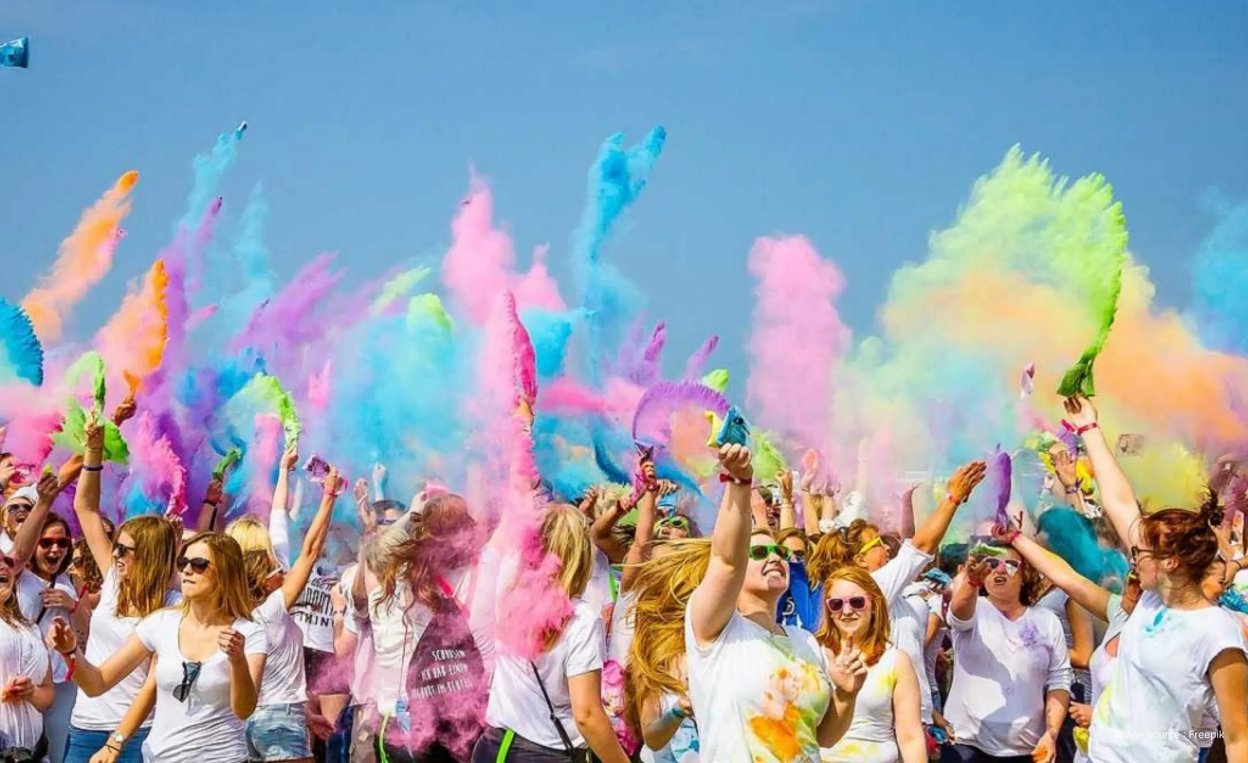 white people celebrating holi by throwing beautiful colors in the air