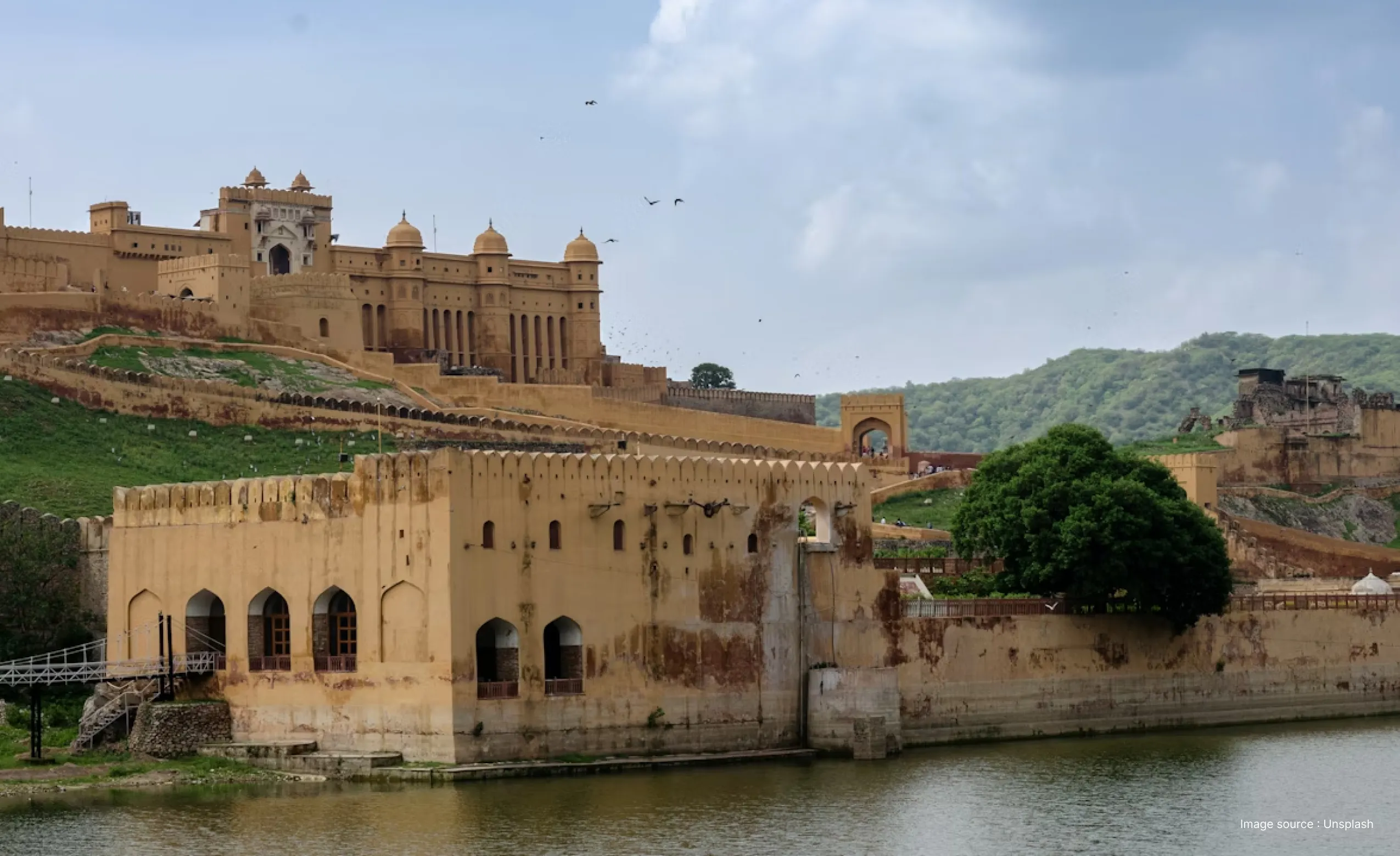 a view of the amer fort on a clear day showcasing its golden structures