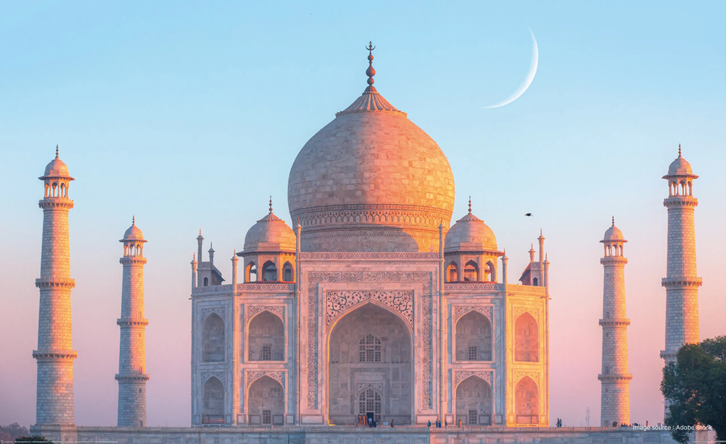 the breathtaking marble building of the taj mahal at sunset with the crescent moon visible in the sky