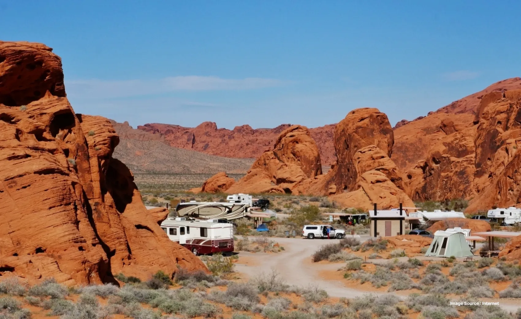 camping setups in the valley of fire area with large red cliffs surrounding them