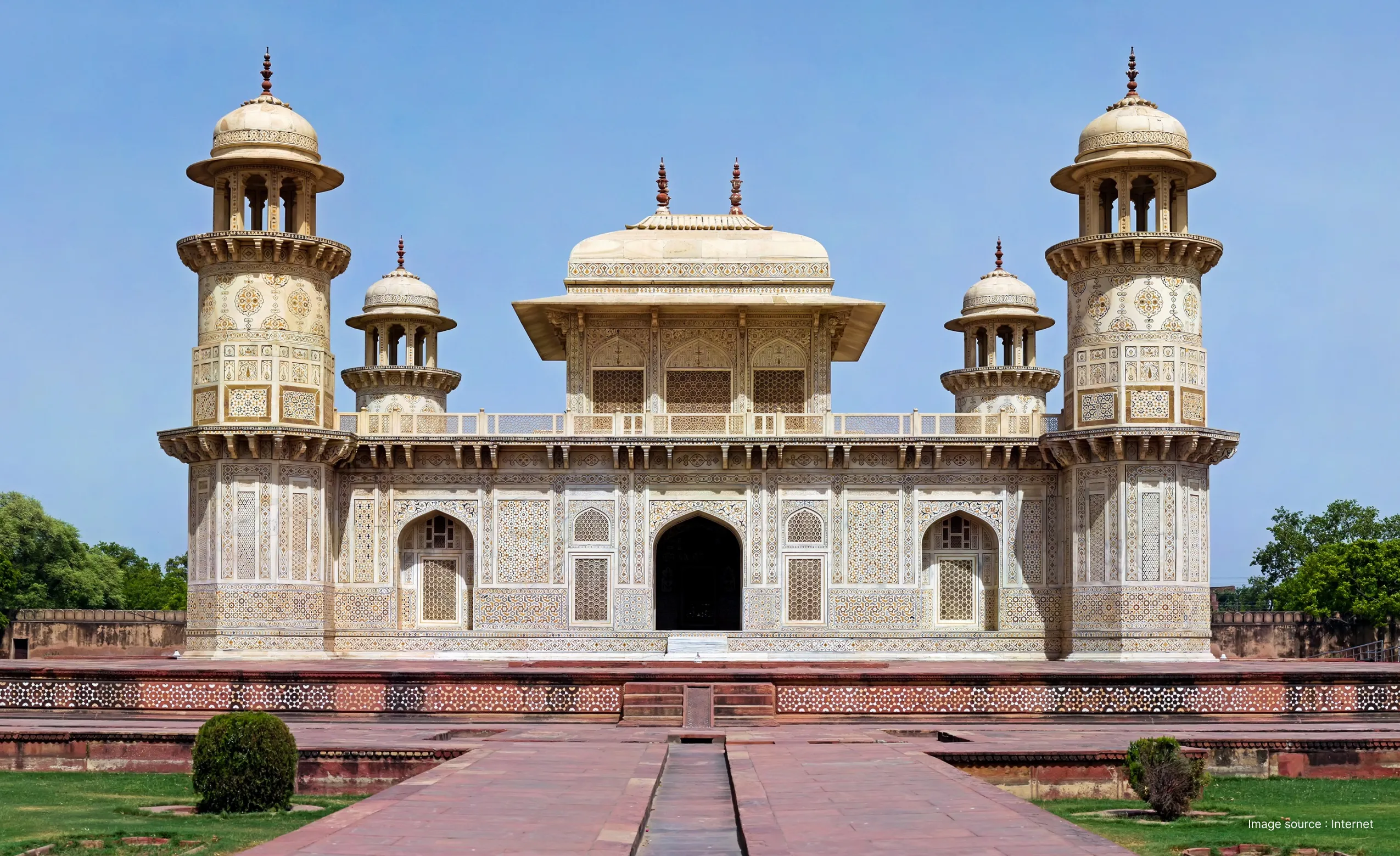 a front view of the intricately carved marble building of the itimad ud daulah tomb in agra during the day
