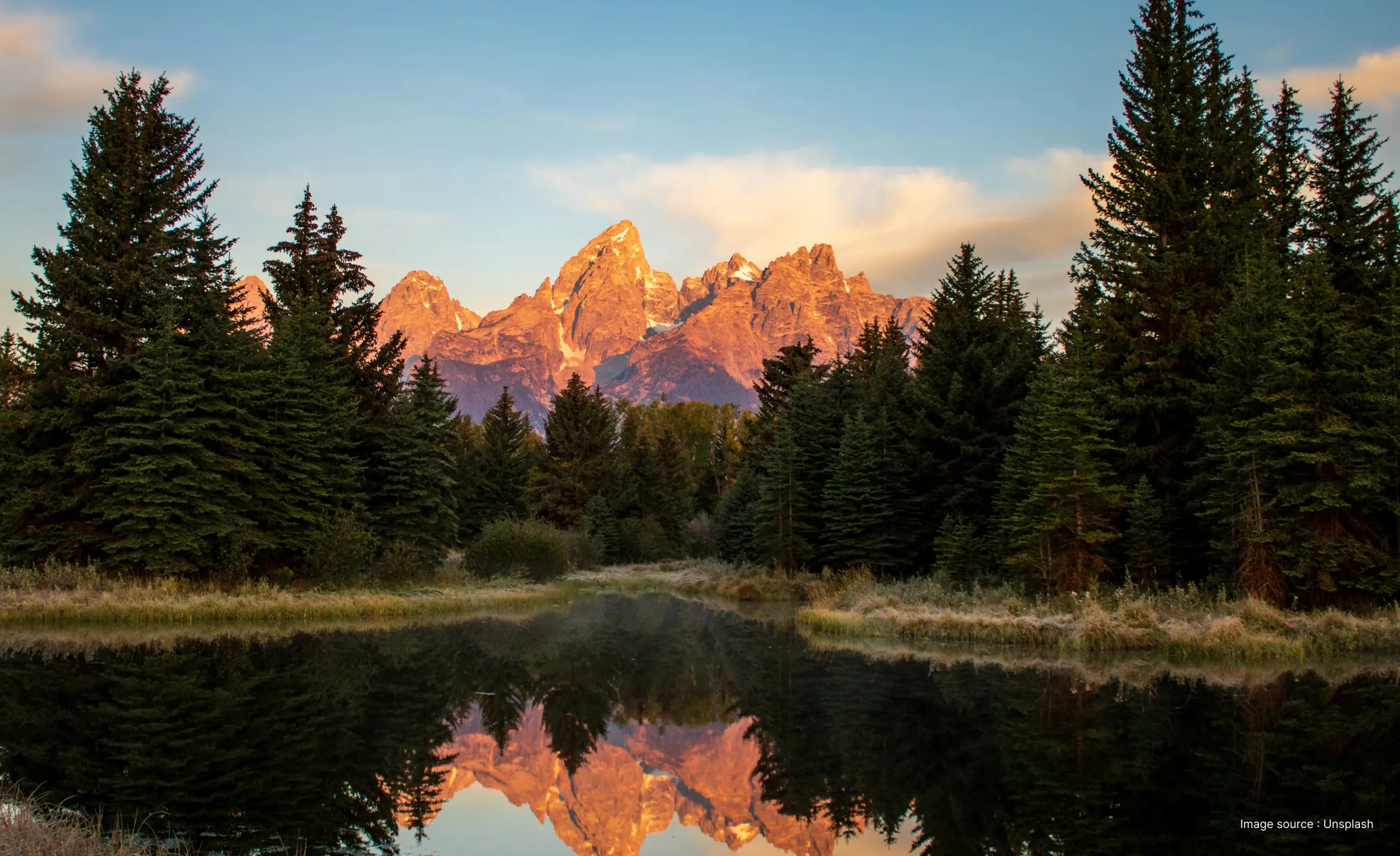 sunrise in the grand teton national park by the snake river as sunlight graces the peaks