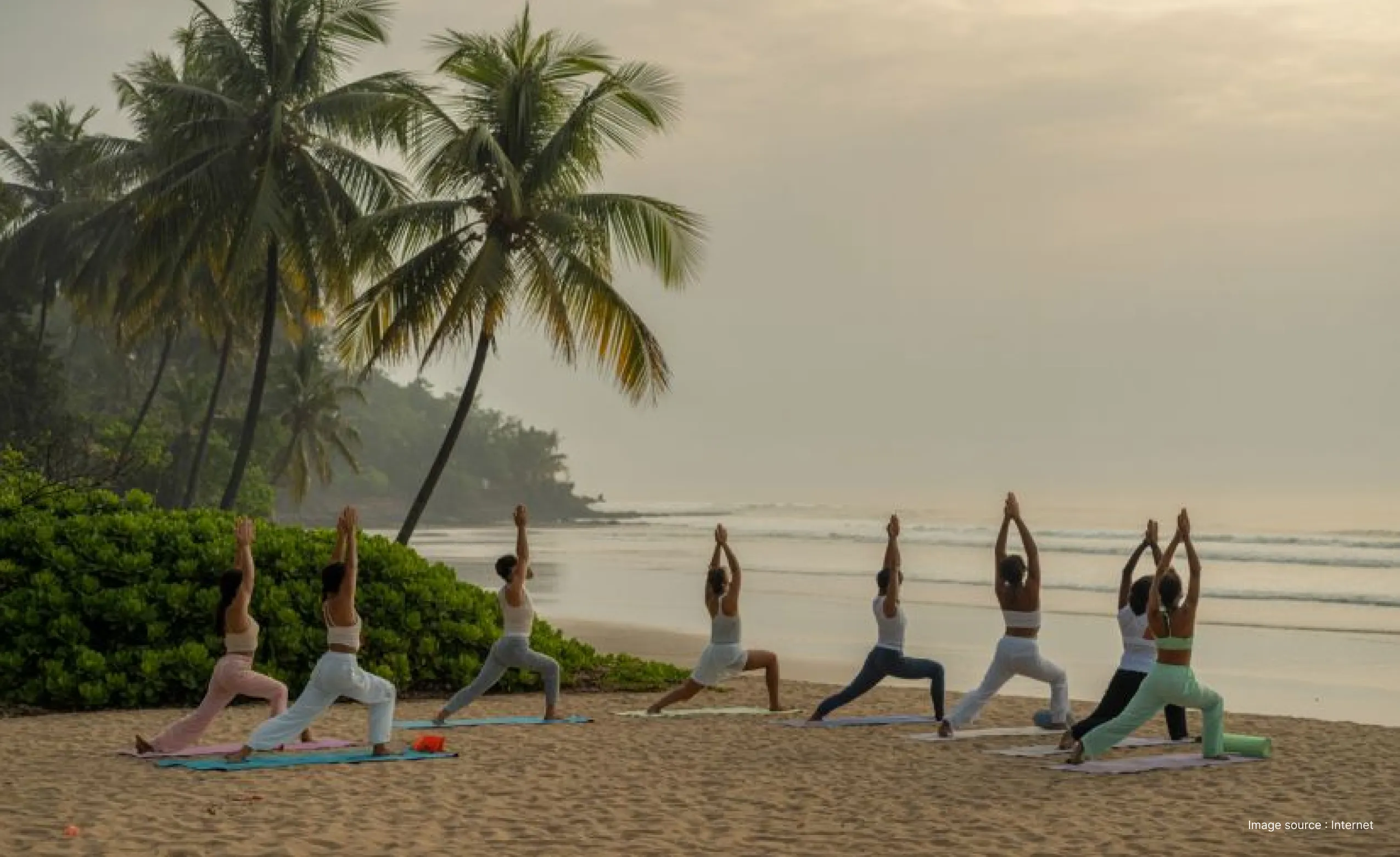 a group yoga session at a beautiful beach
