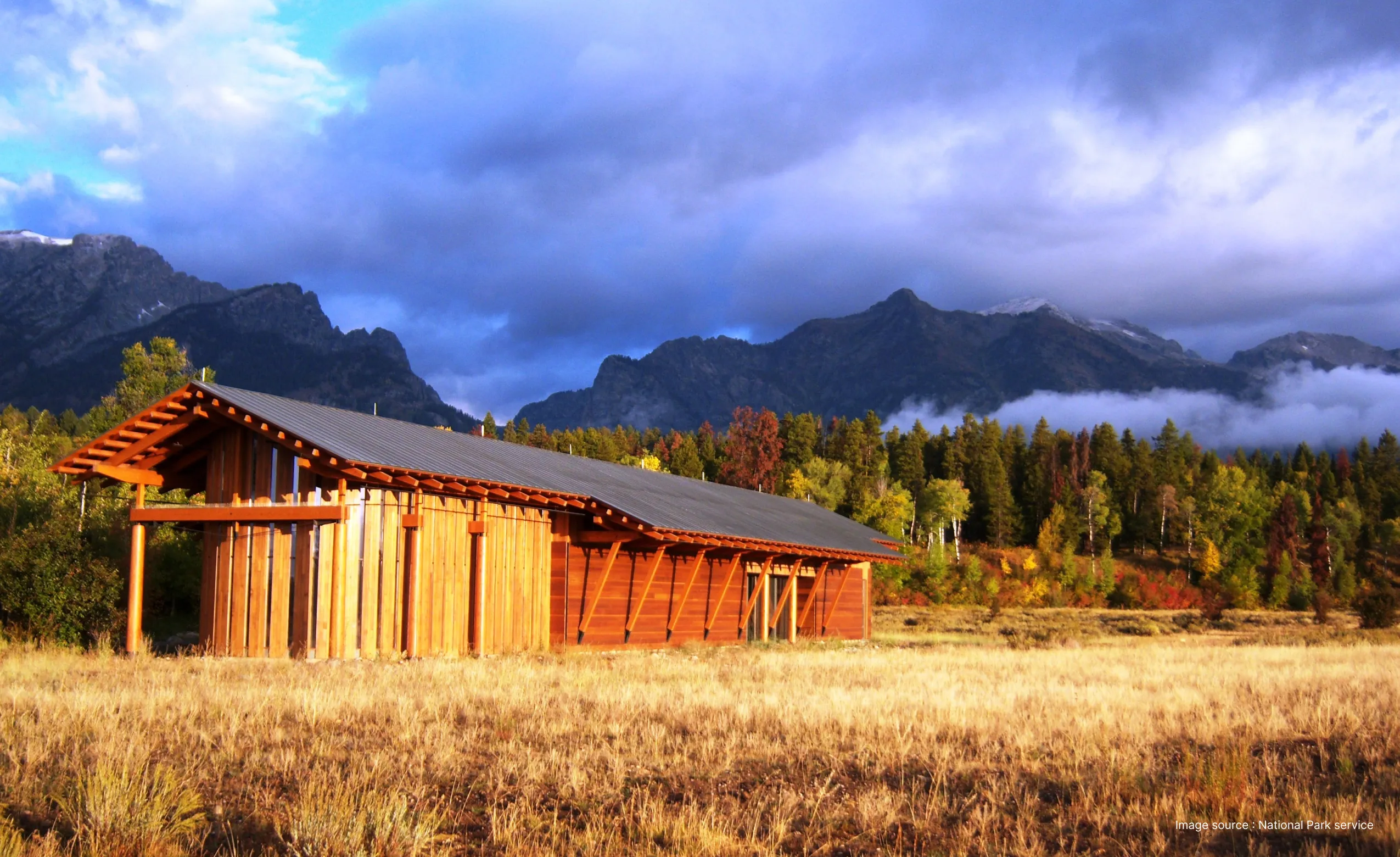 a wooden barn in the laurece rockfeller preserve on a sunny day surrounded by dry grass